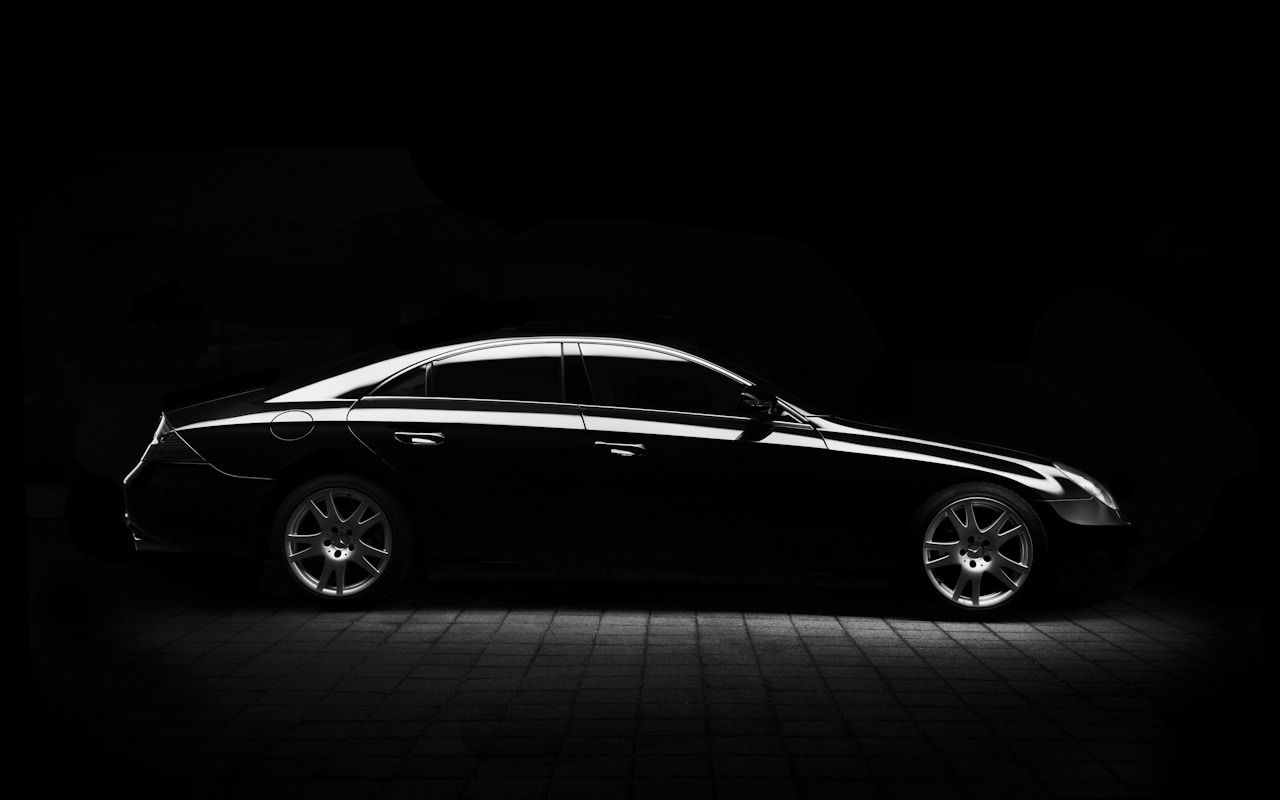 Luxury sedan profile with polished chrome wheels