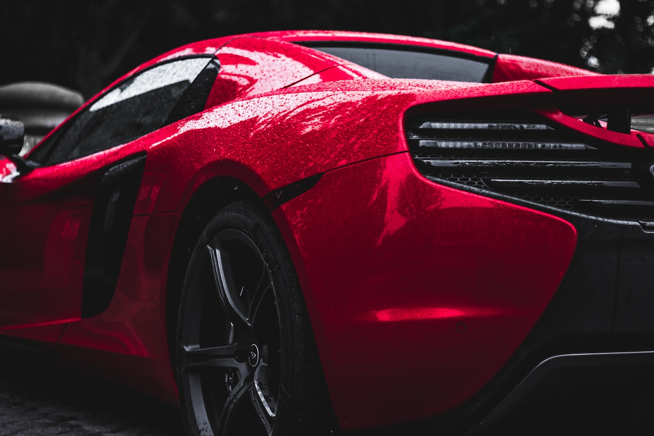 Red supercar with beading water on ceramic-coated paint